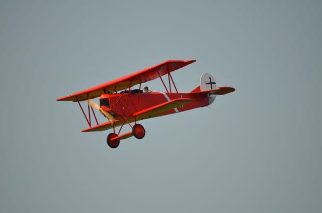 A model airplane flying above the field