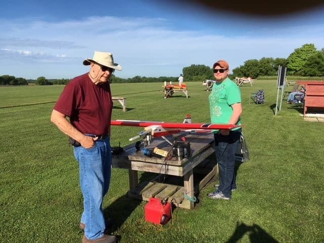 Club members and a model airplane at the flying field